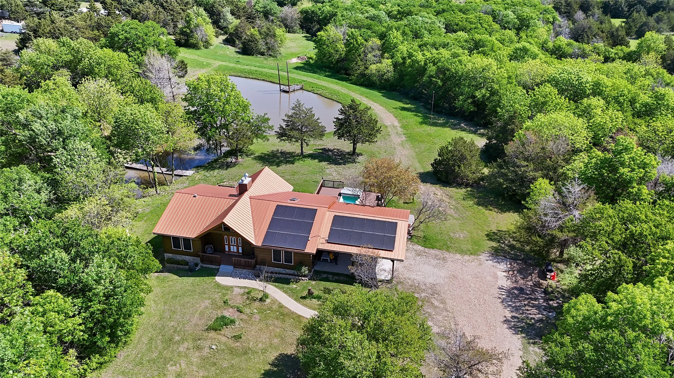 Metal Roof, Solar panels, Swim Spa, "Tear Drop Pond" with dock and bridge. Shop/Apartment top left corner.