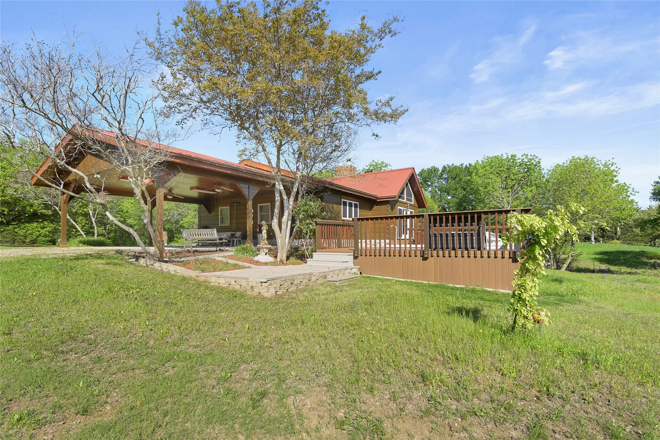 View of Carport, native landscaping, Deck and Swim Spa.