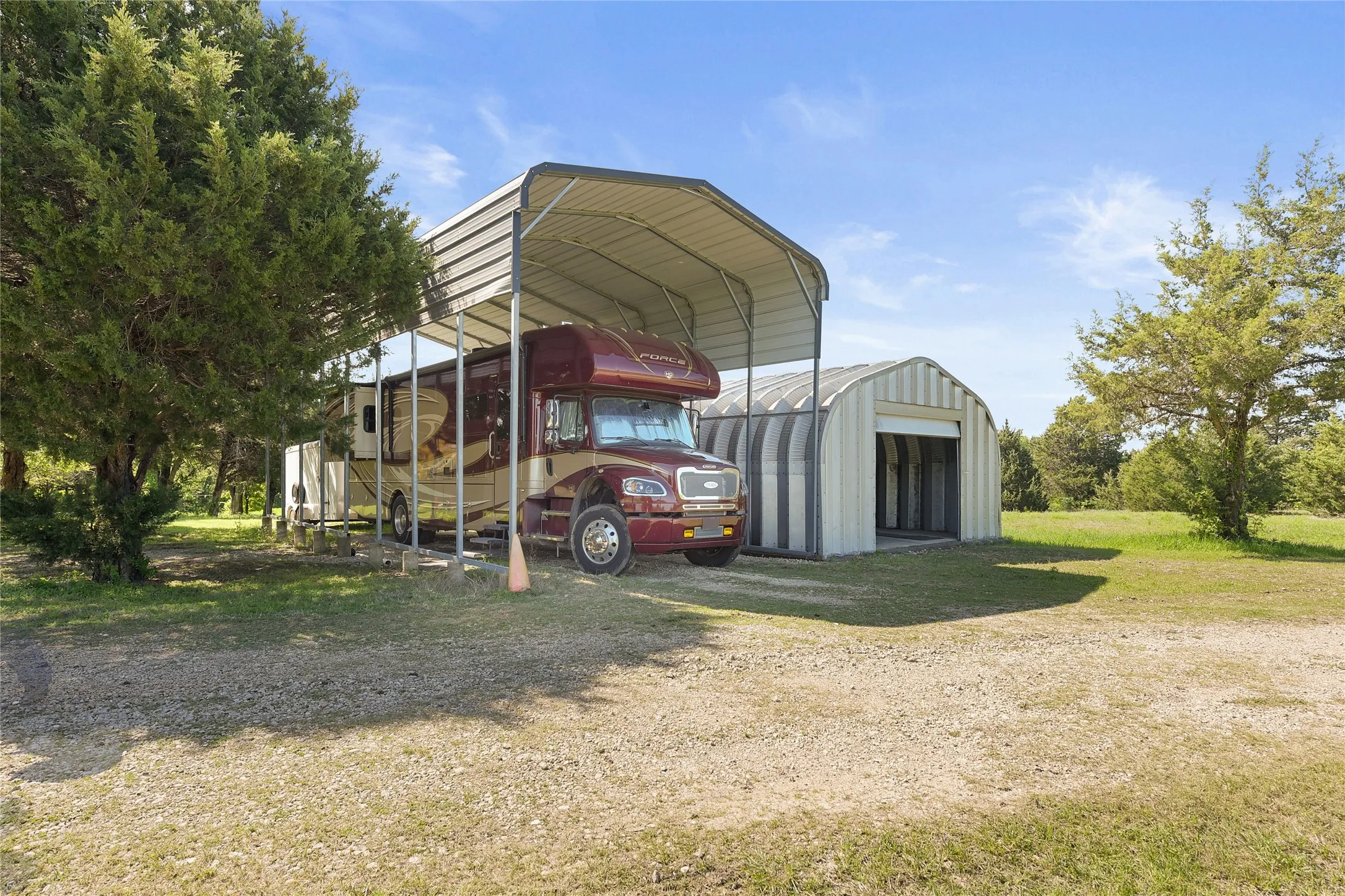 4-car Quonset hut. 40', 30 amp covered RV spot. RV and Trailer Excluded.