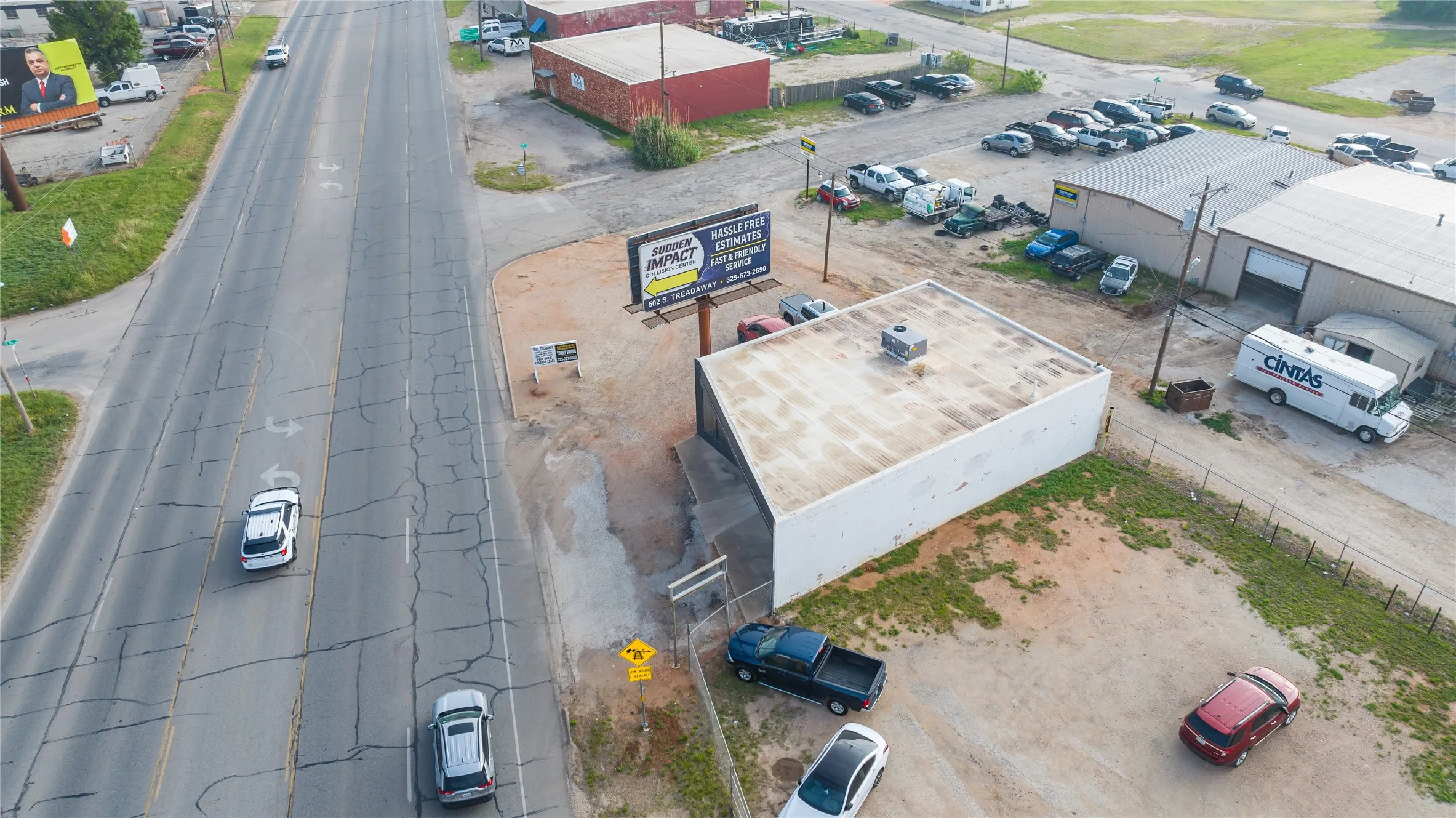 Commercial building with a unique angled facade, prominent roadside signage, and a flat roofline