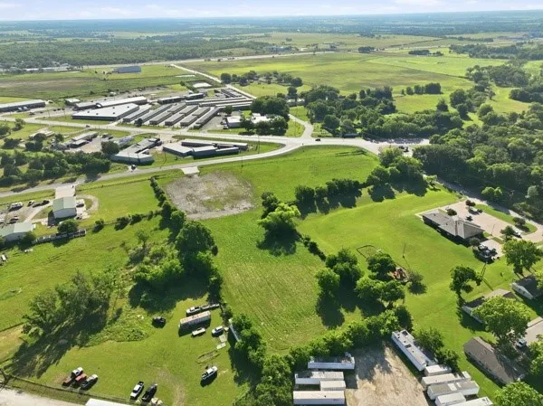 Expansive green landscape featuring varied terrain and scattered tree lines