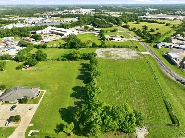 Expansive green acreage with established tree lines