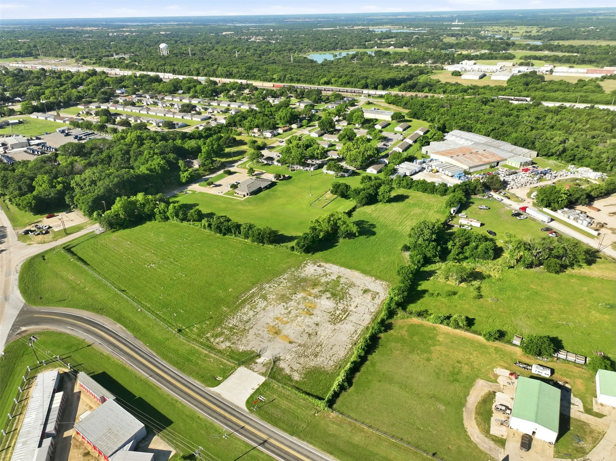 Expansive green land parcels surrounded by natural foliage