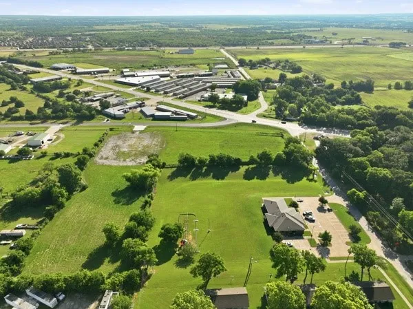 Expansive aerial view showcasing verdant green spaces and scattered trees