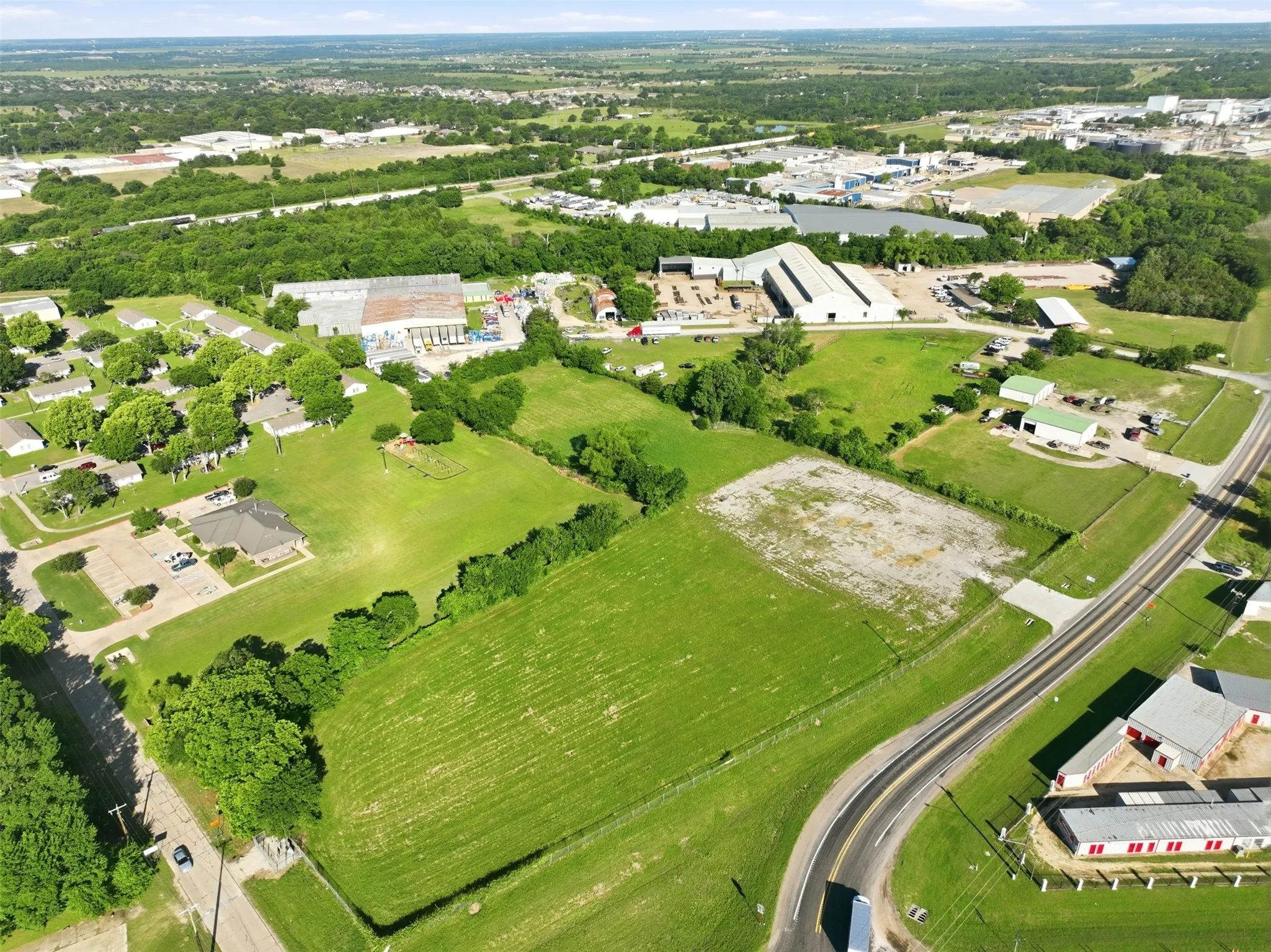 Expansive green acreage with visible road frontage