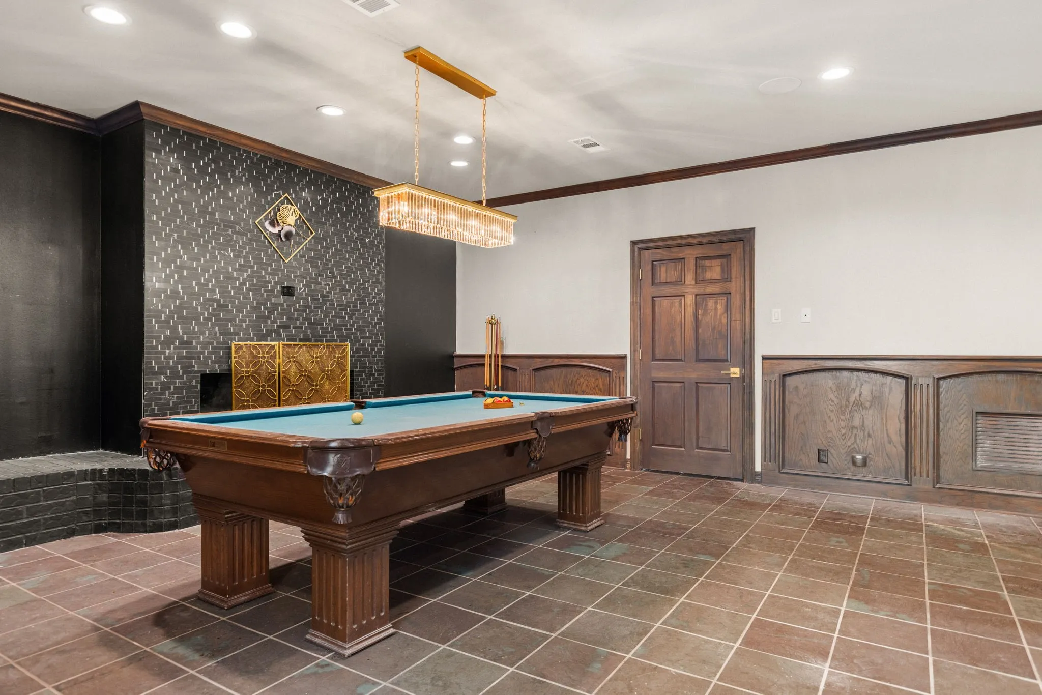 Recreation room featuring a pool table, dark wood door, recessed lighting, and a textured accent wall