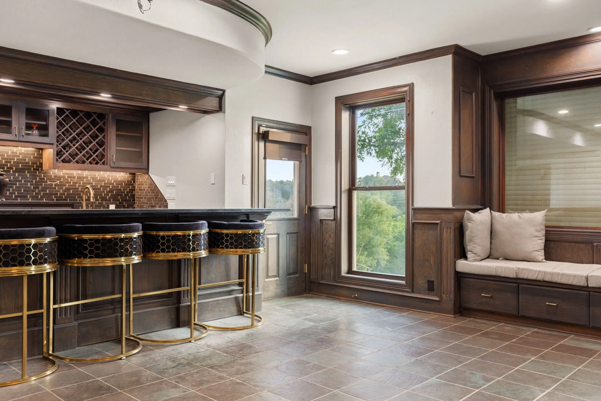 Built-in wet bar featuring dark wood cabinetry, a wine rack, and a tile backsplash
