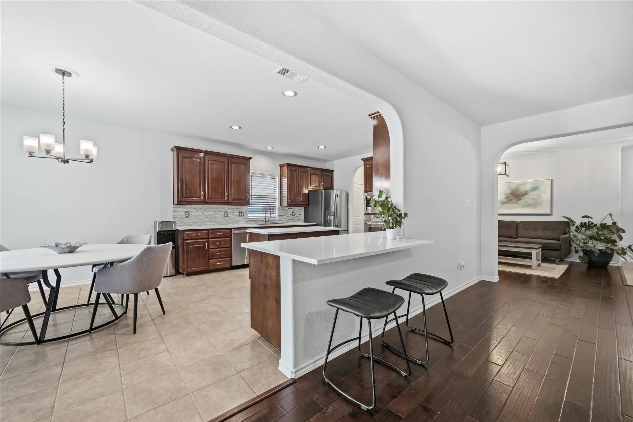 Kitchen featuring rich wood cabinetry, stainless steel appliances, and a mosaic tile backsplash