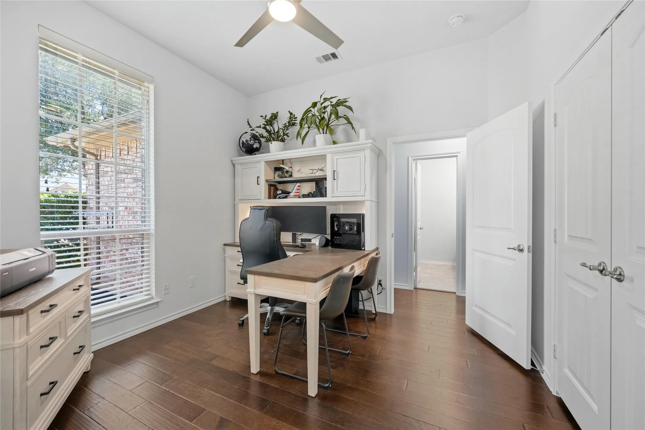 Room featuring wood-finish flooring, a vaulted ceiling, and a ceiling fan
