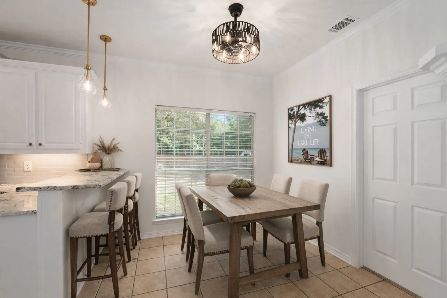 Kitchen with dining area plus bar seating. Fireplace in kitchen.