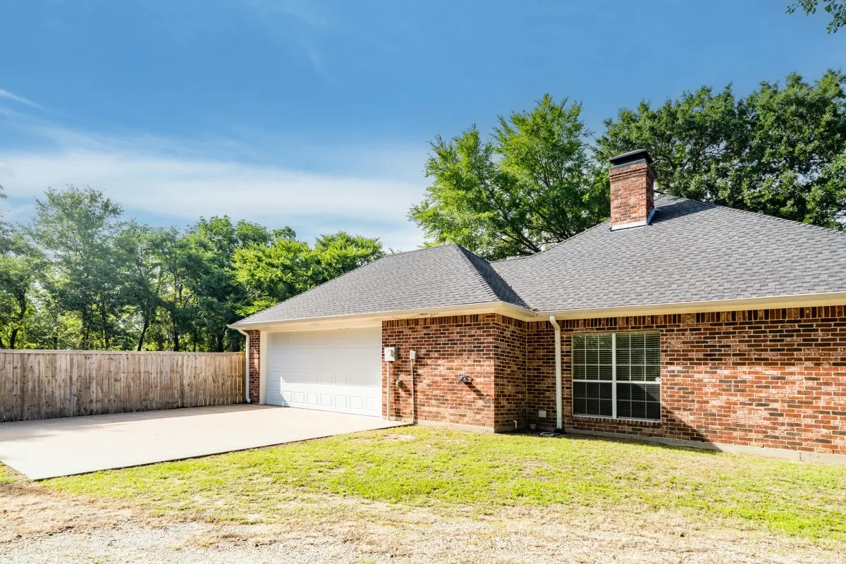 Two car garage with concrete driveway.