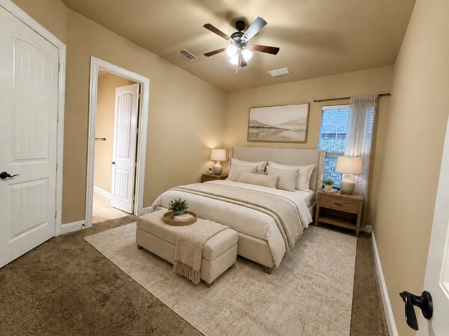Carpeted bedroom featuring a ceiling fan with integrated lighting, a window with blinds, and two paneled doors with black hardware