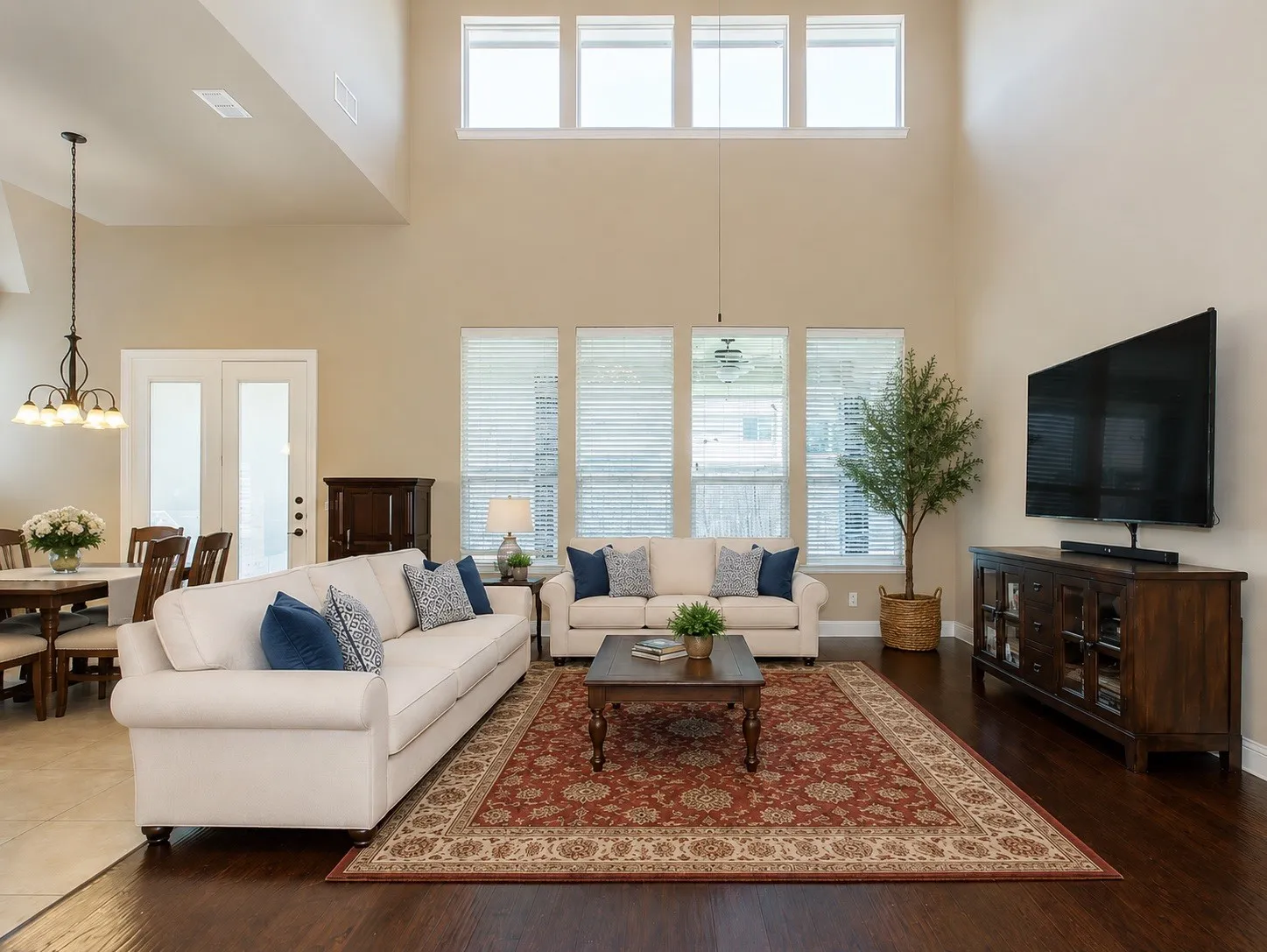 Expansive living area featuring soaring ceilings and wood-finish flooring