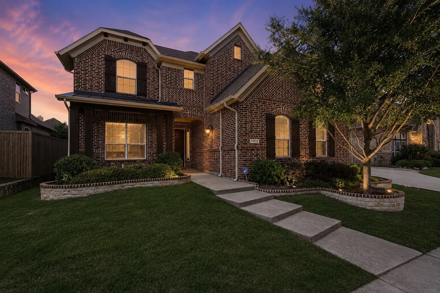 Brick exterior with dark wood shutters and a gabled roof