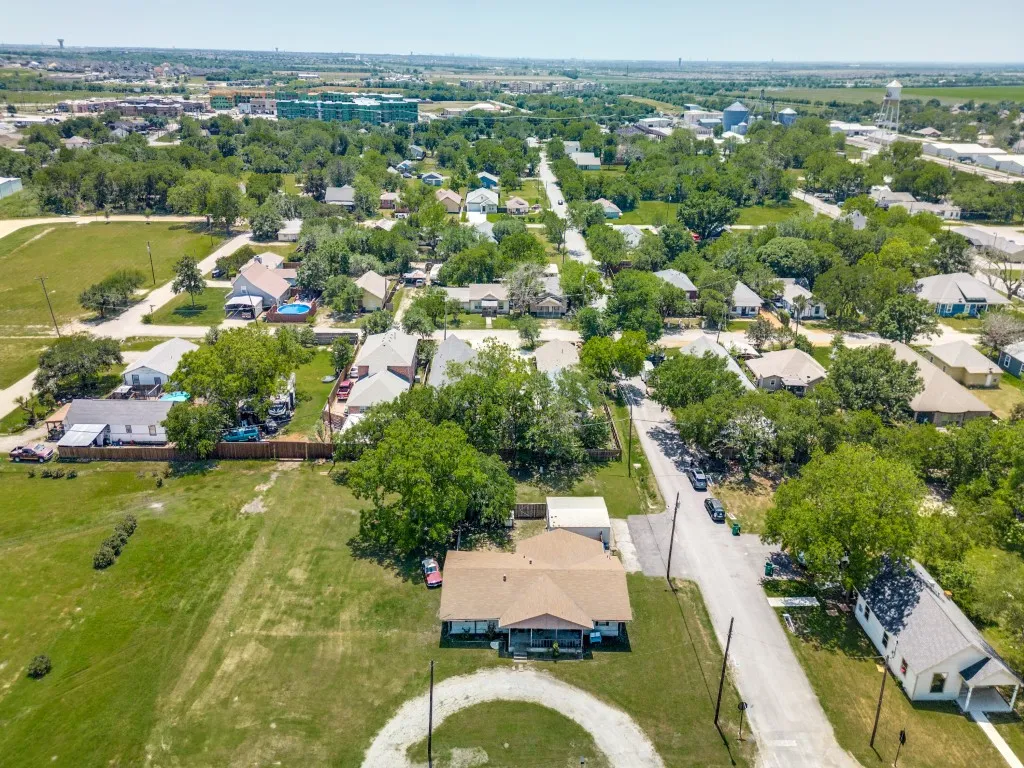 Aerial view, showing the property, continuing to the residential areas behind. Left is East, Right is West.