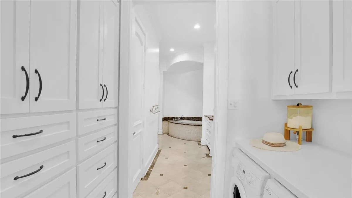 2nd Laundry in master suite  with custom cabinetry for additional storage