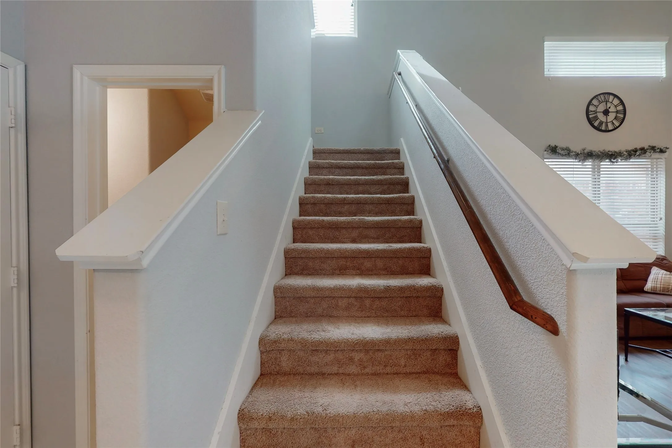 Stairway to indoor balcony and bedrooms.