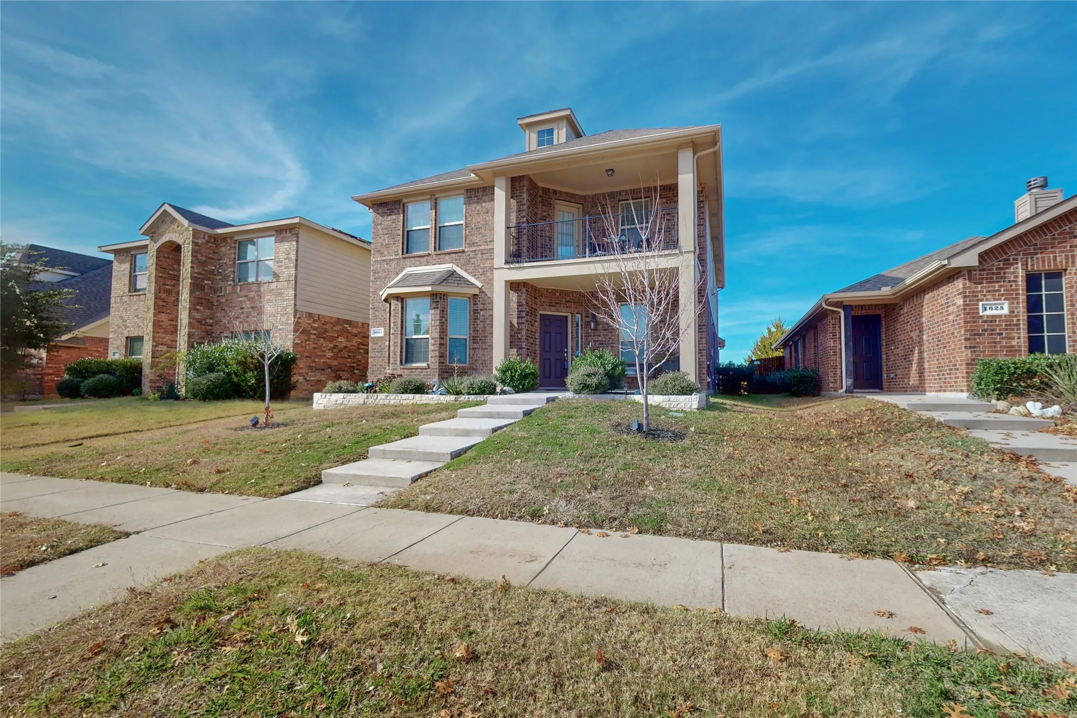 Impressive home with upstairs covered balcony.