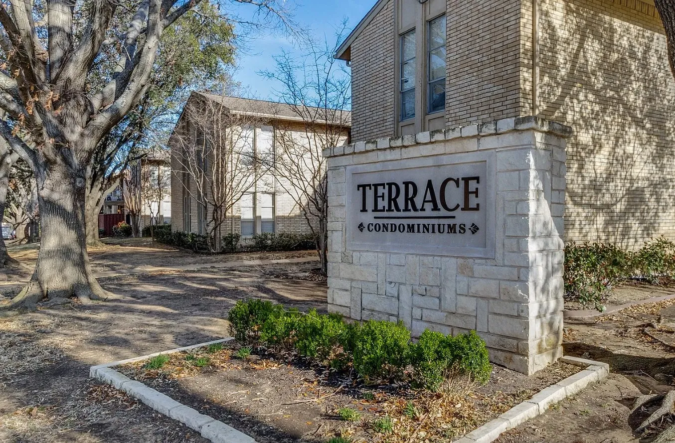 Stone monument signage for Terrace Condominiums with integrated landscaping