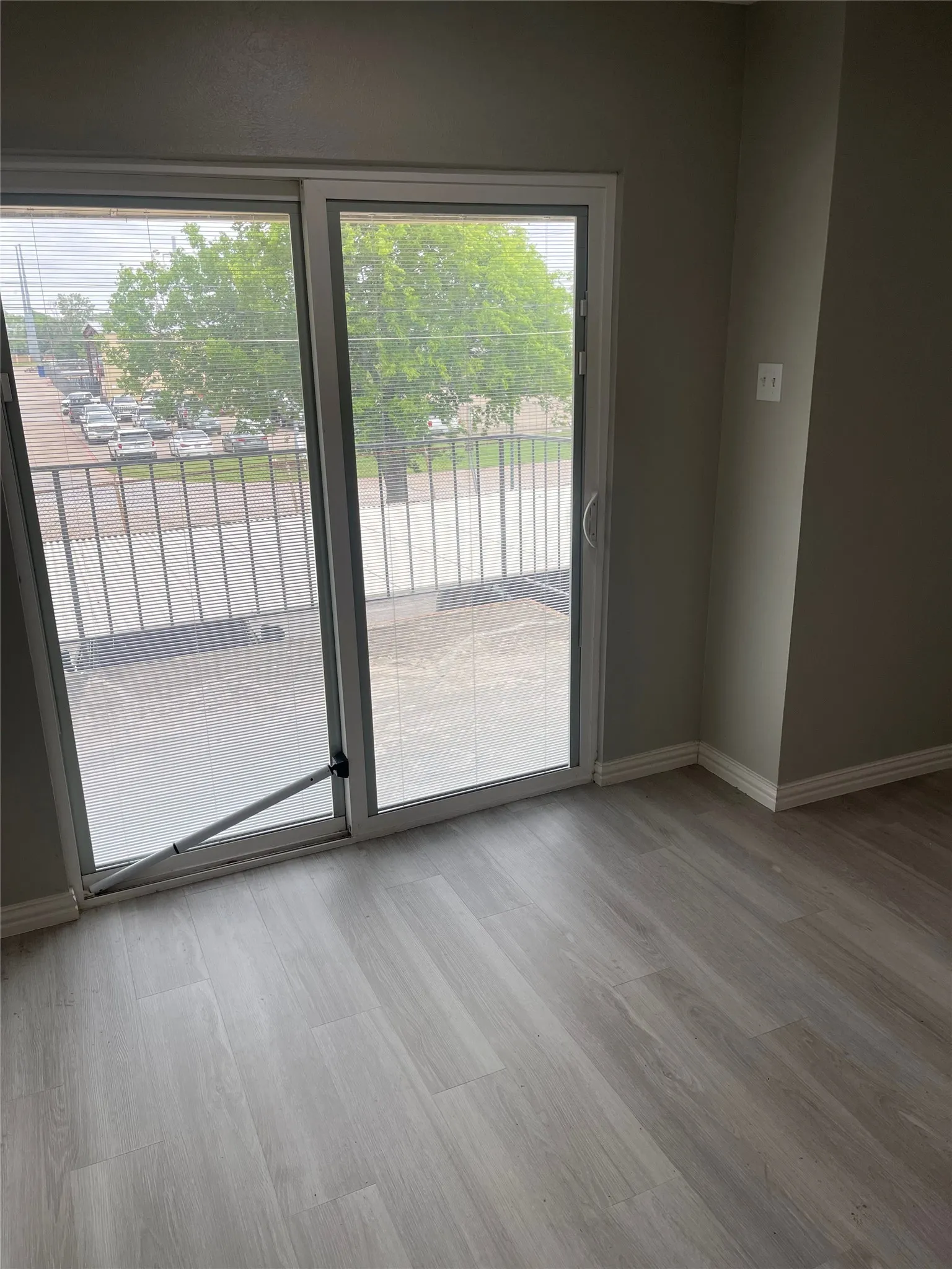 Light gray wood-finish flooring complements the neutral wall tones