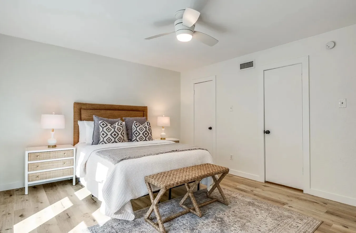 Bright interior featuring wood-finish flooring and a ceiling fan with integrated lighting