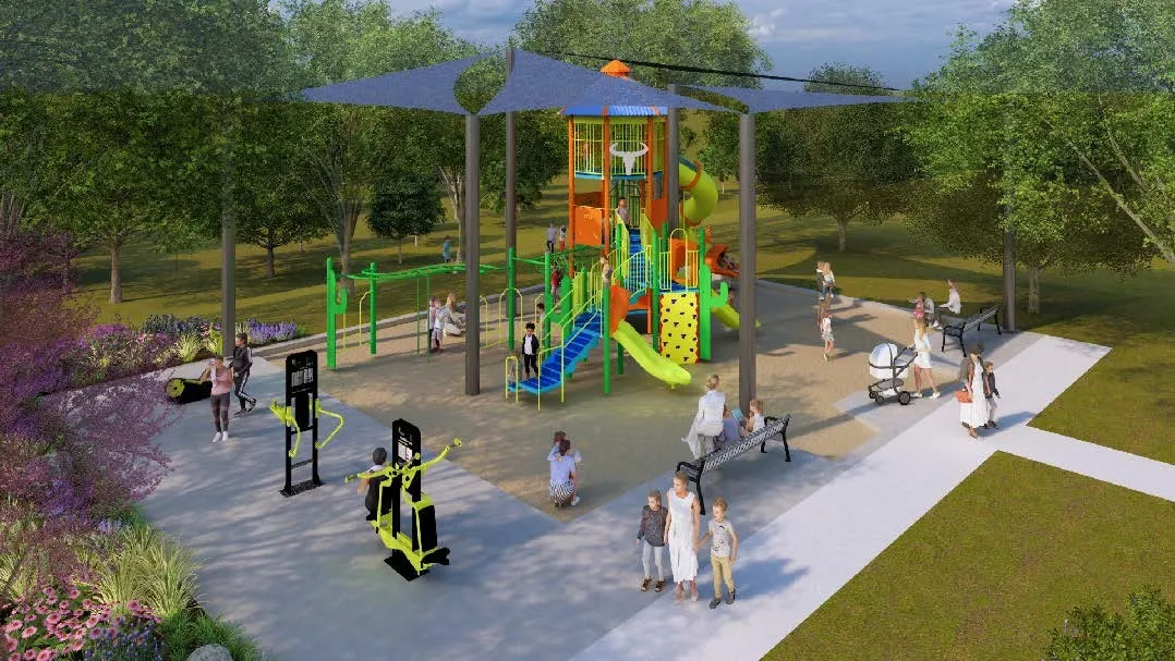 Outdoor recreational area featuring a multi-level playground structure with slides and climbing elements, shaded by large canopy sails
