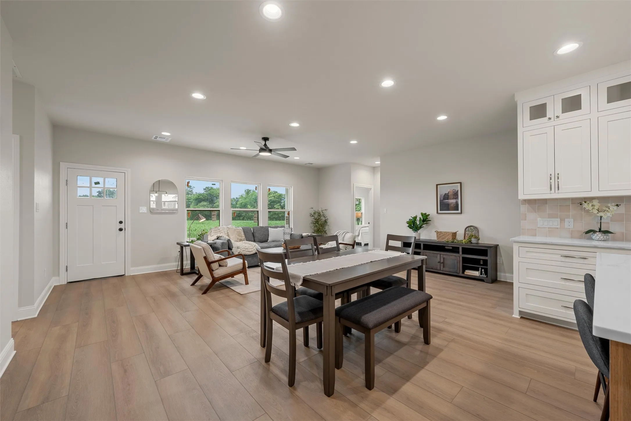 Open-concept living area featuring wood-finish flooring, recessed lighting, and a ceiling fan
