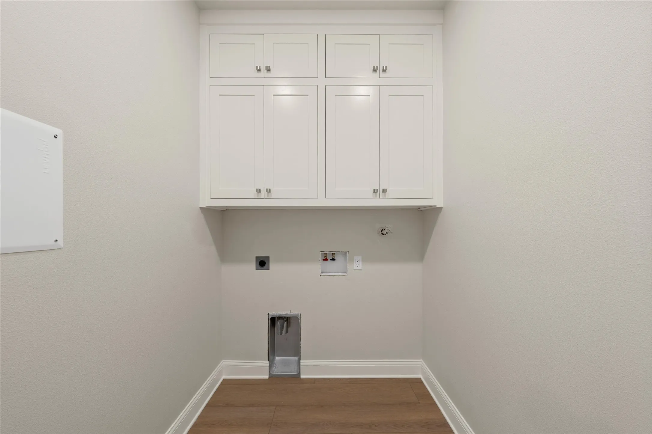 White shaker cabinetry with silver-tone hardware