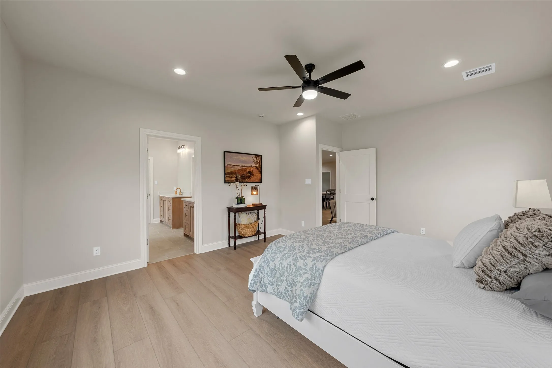 Spacious room featuring wood-finish flooring, recessed lighting, and a contemporary ceiling fan