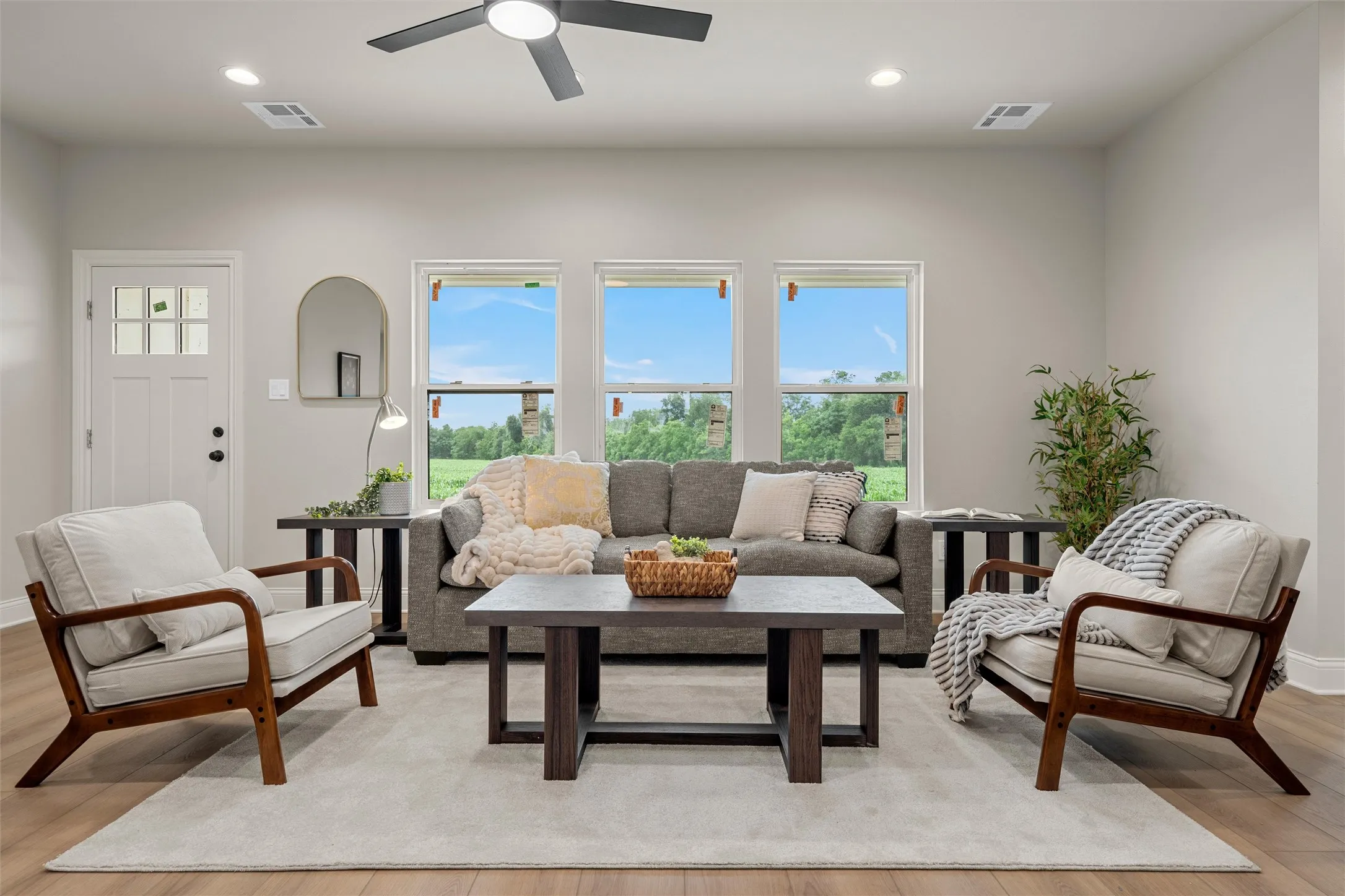 Bright living space featuring light wood-finish flooring and a neutral color palette