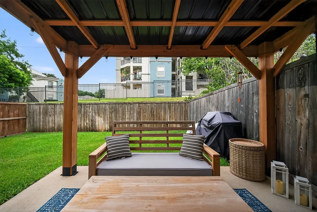 Covered patio with wood-frame structure and black metal roof