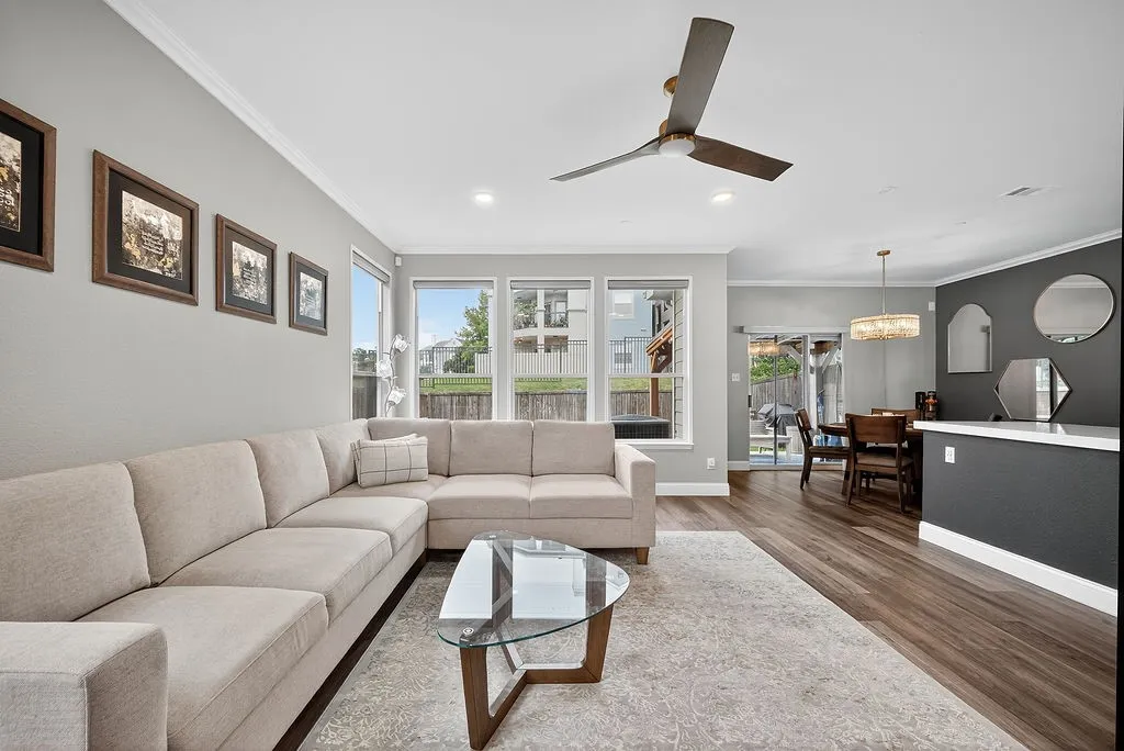 Open-concept living space featuring wood-finish flooring, recessed lighting, and a modern ceiling fan
