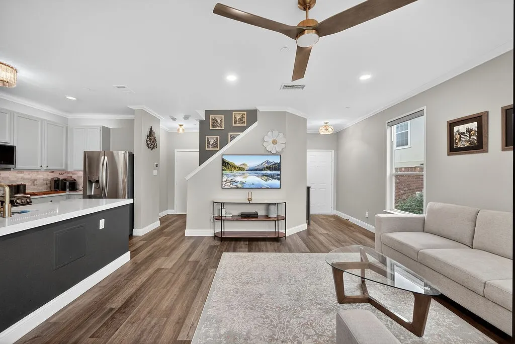 Open-concept living space featuring wood-finish flooring, recessed lighting, and a contemporary ceiling fan
