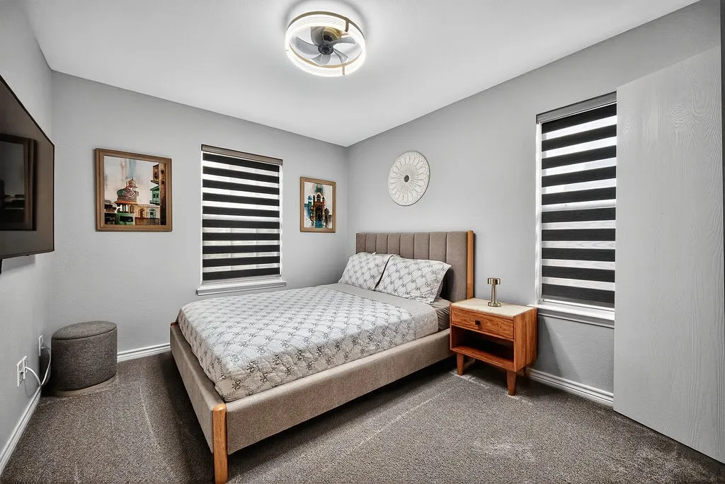 Neutral wall color with two windows featuring horizontal blinds
