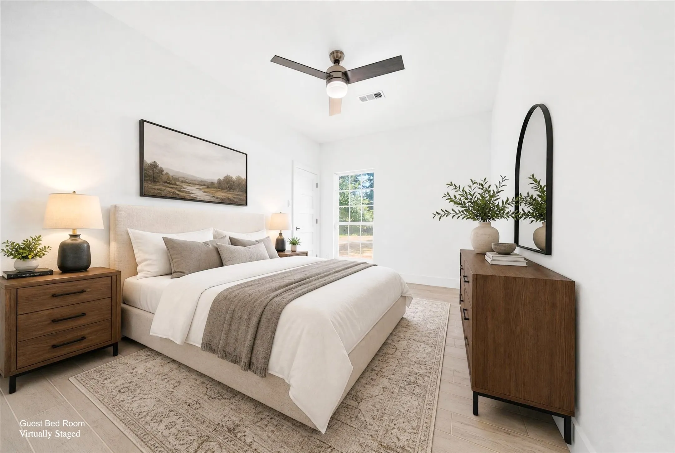 Spacious room featuring light-toned wood-finish flooring, a contemporary ceiling fan with integrated lighting, and white walls