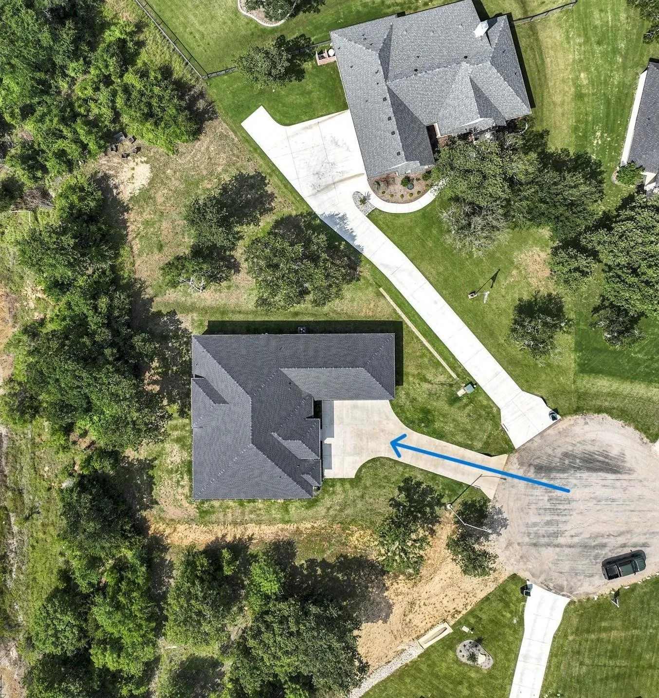Property features a multi-gabled roofline and an attached concrete driveway