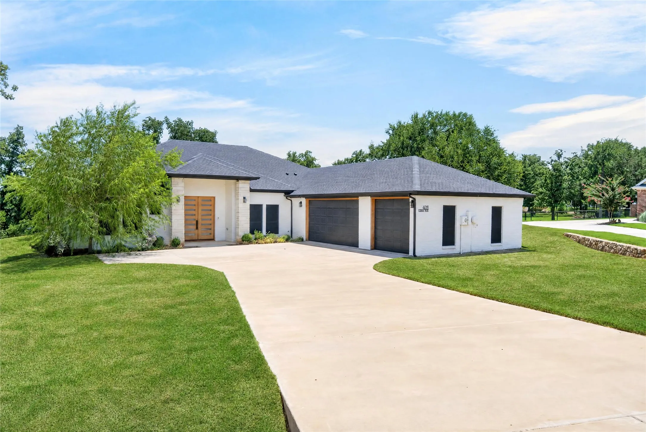 Contemporary exterior featuring white stucco and stone accents