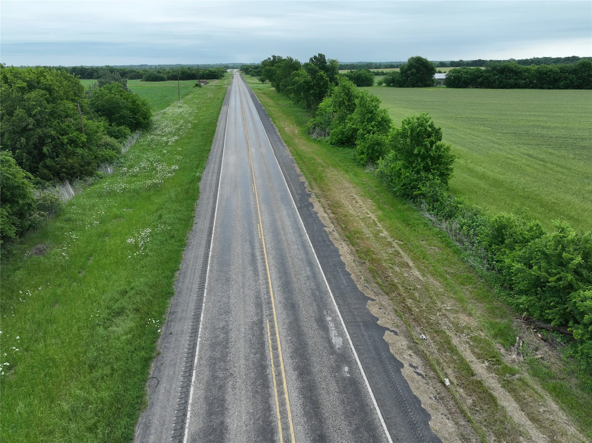 Paved two-lane road extending through agricultural land
