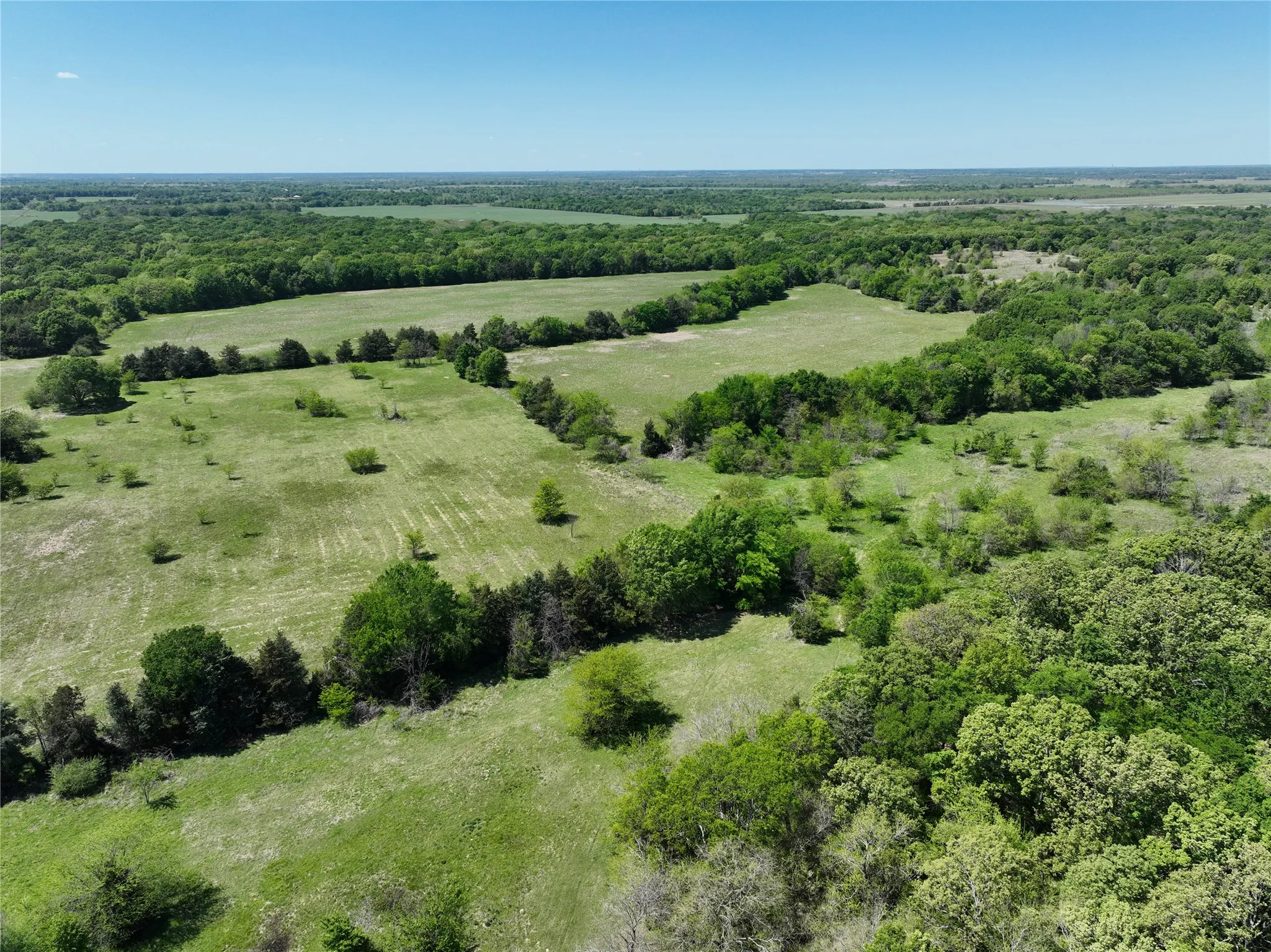 Expansive land offering a combination of open clearings and wooded areas