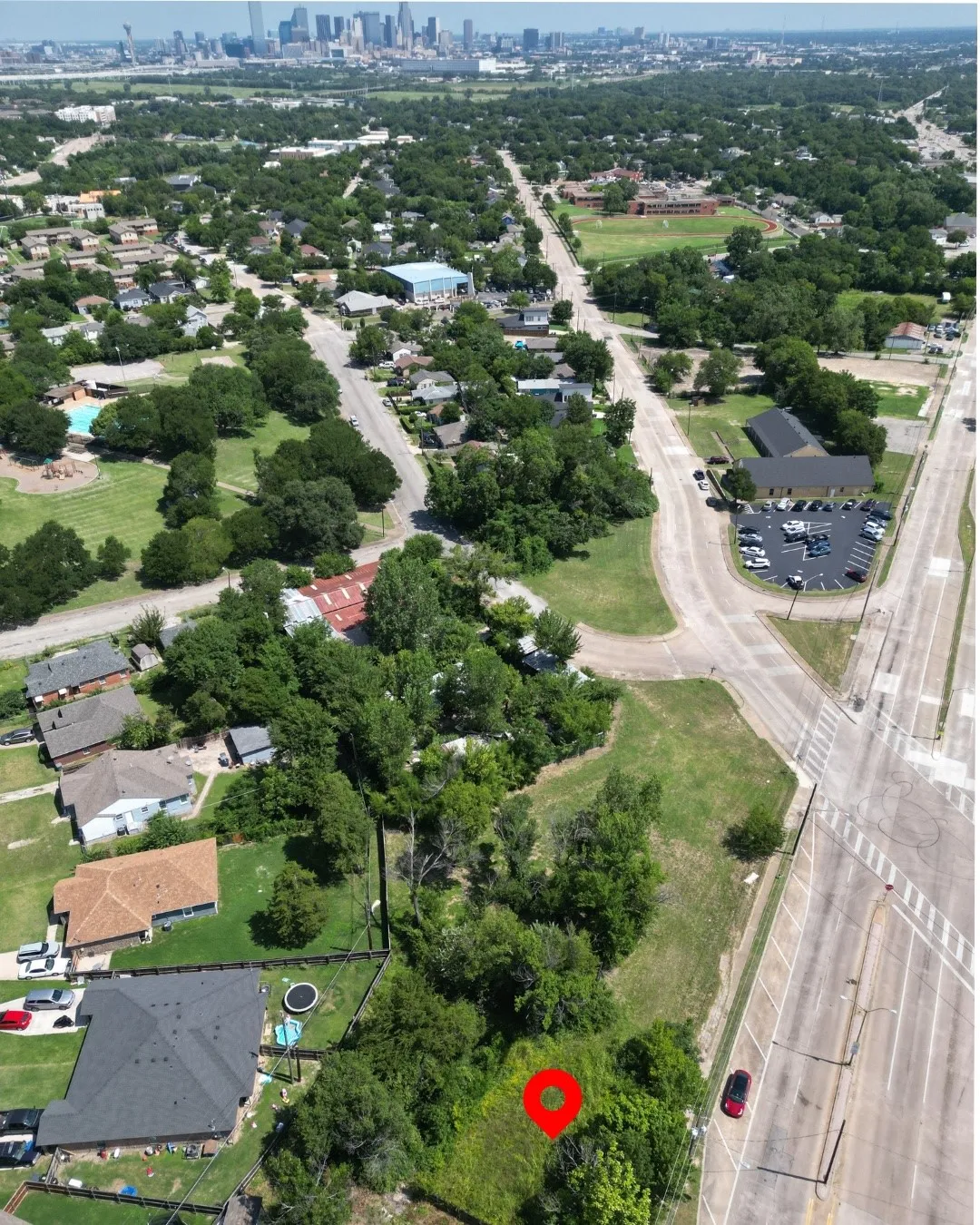 Aerial perspective showcasing a property surrounded by mature trees