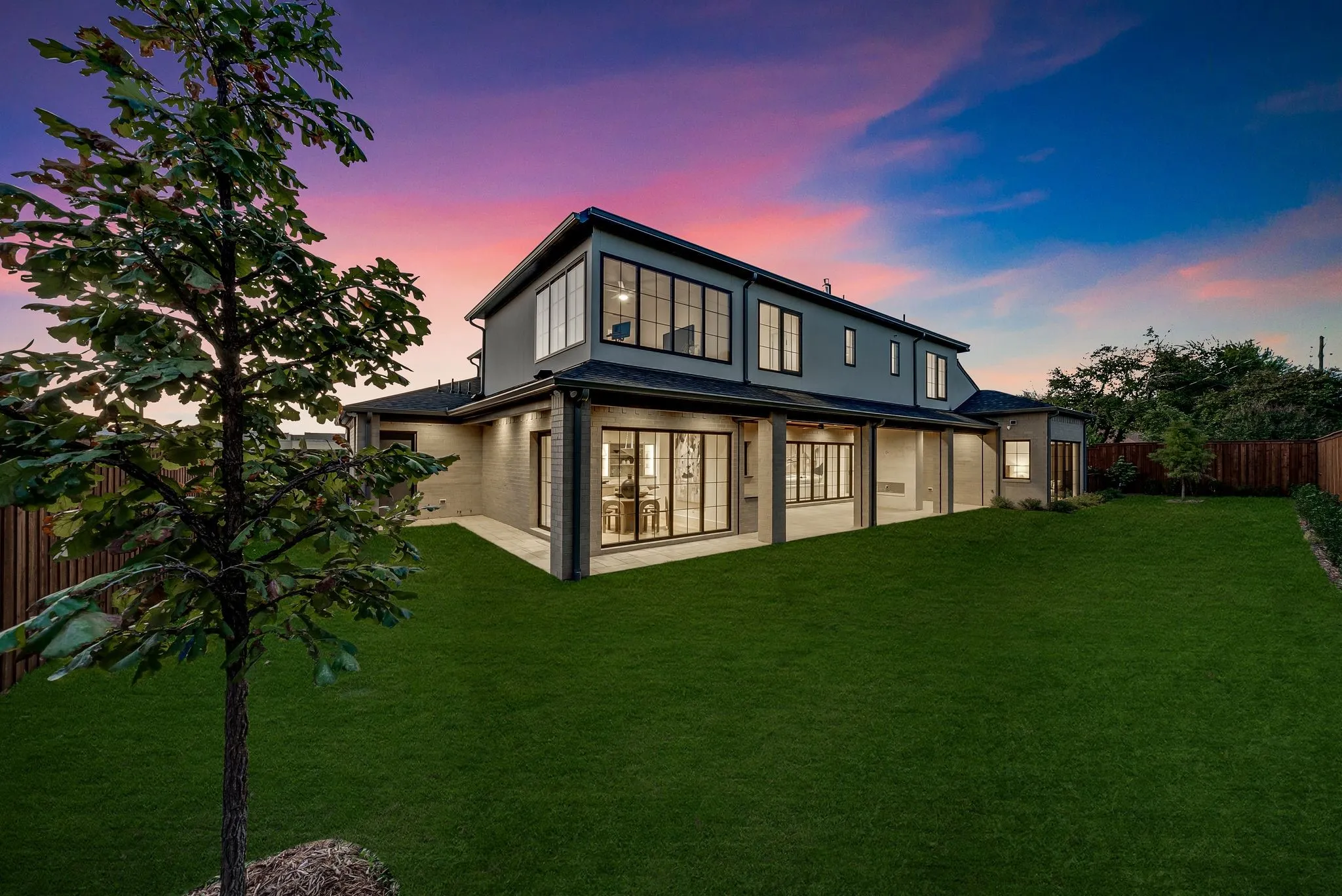 Back of house featuring a fenced backyard, a patio, and stucco siding