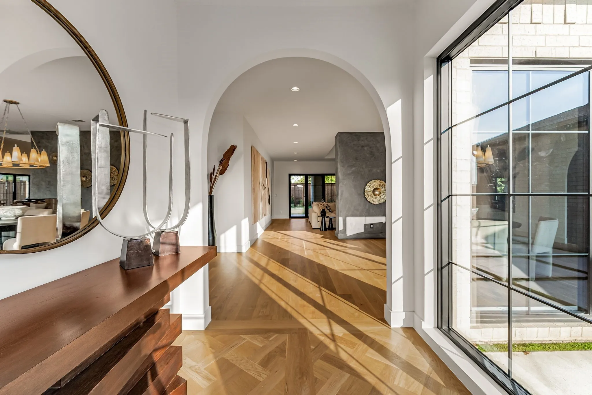 Foyer entrance with recessed lighting, arched walkways, and parquet flooring