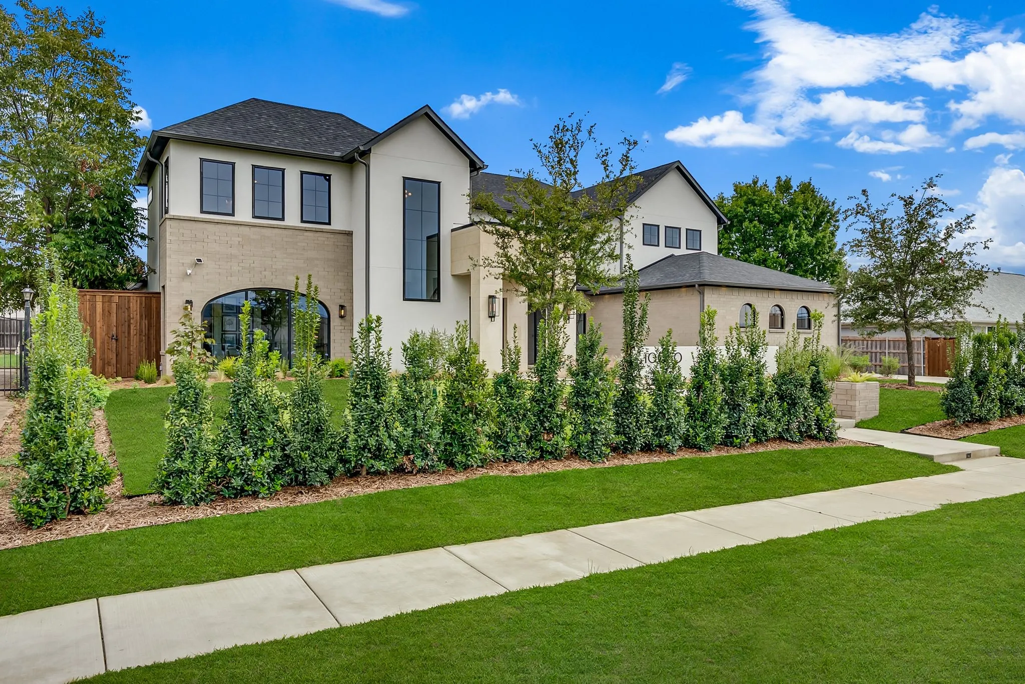 View of front of home featuring stucco siding and brick siding