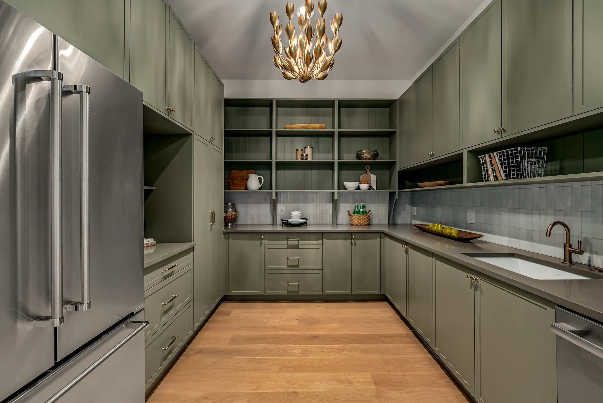 Kitchen featuring stainless steel appliances, light wood finished floors, a chandelier, decorative backsplash, and open shelves