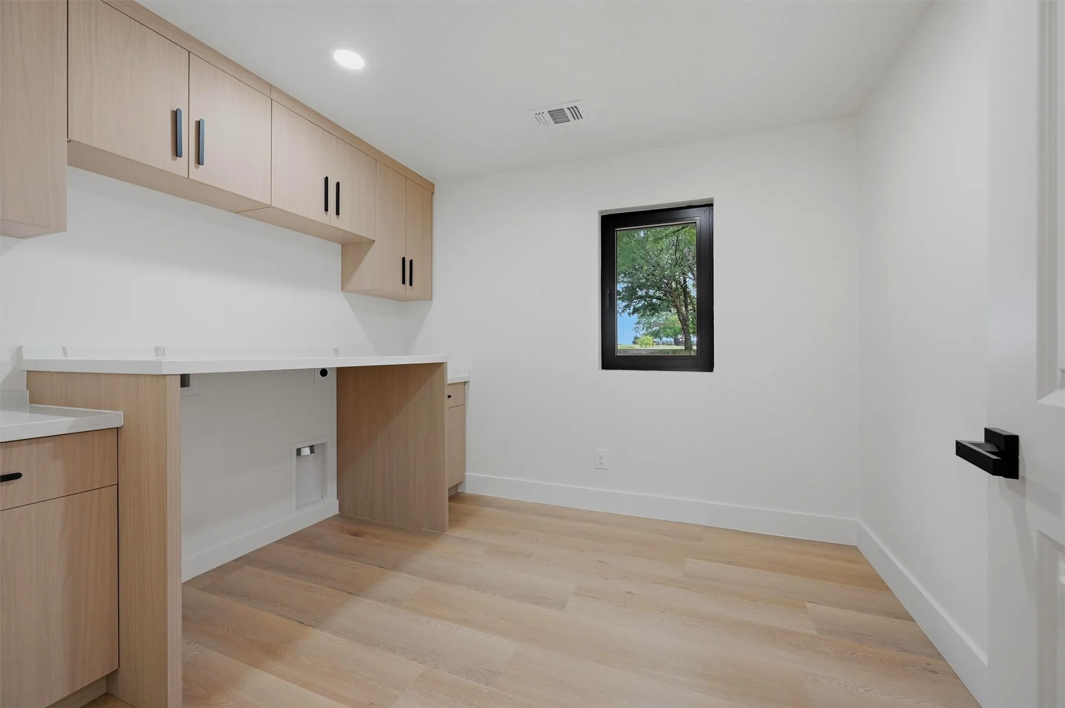Large laundry room with ample storage space and room for a full size washer/dryer