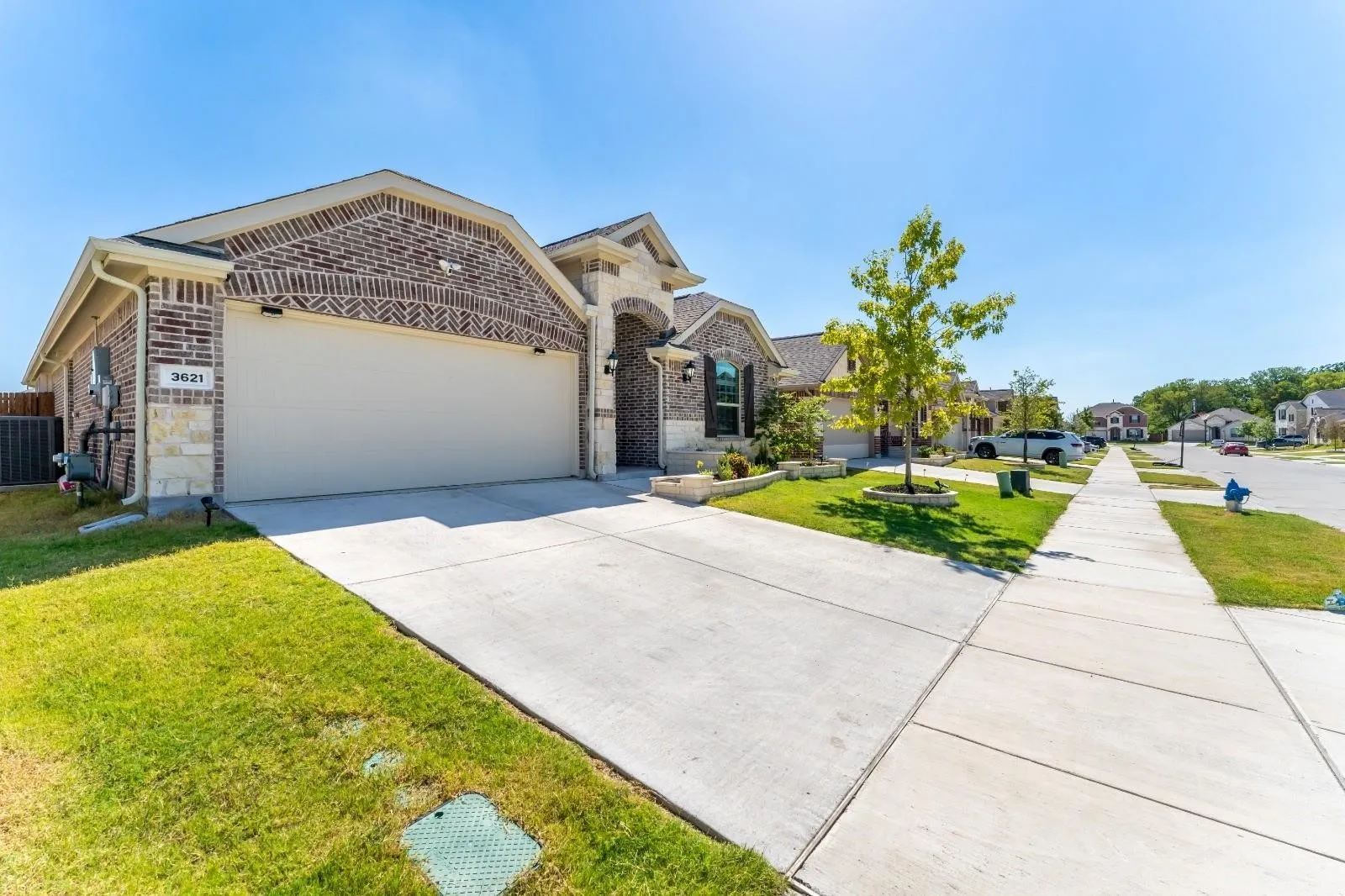 View of front of property featuring a front lawn and a garage