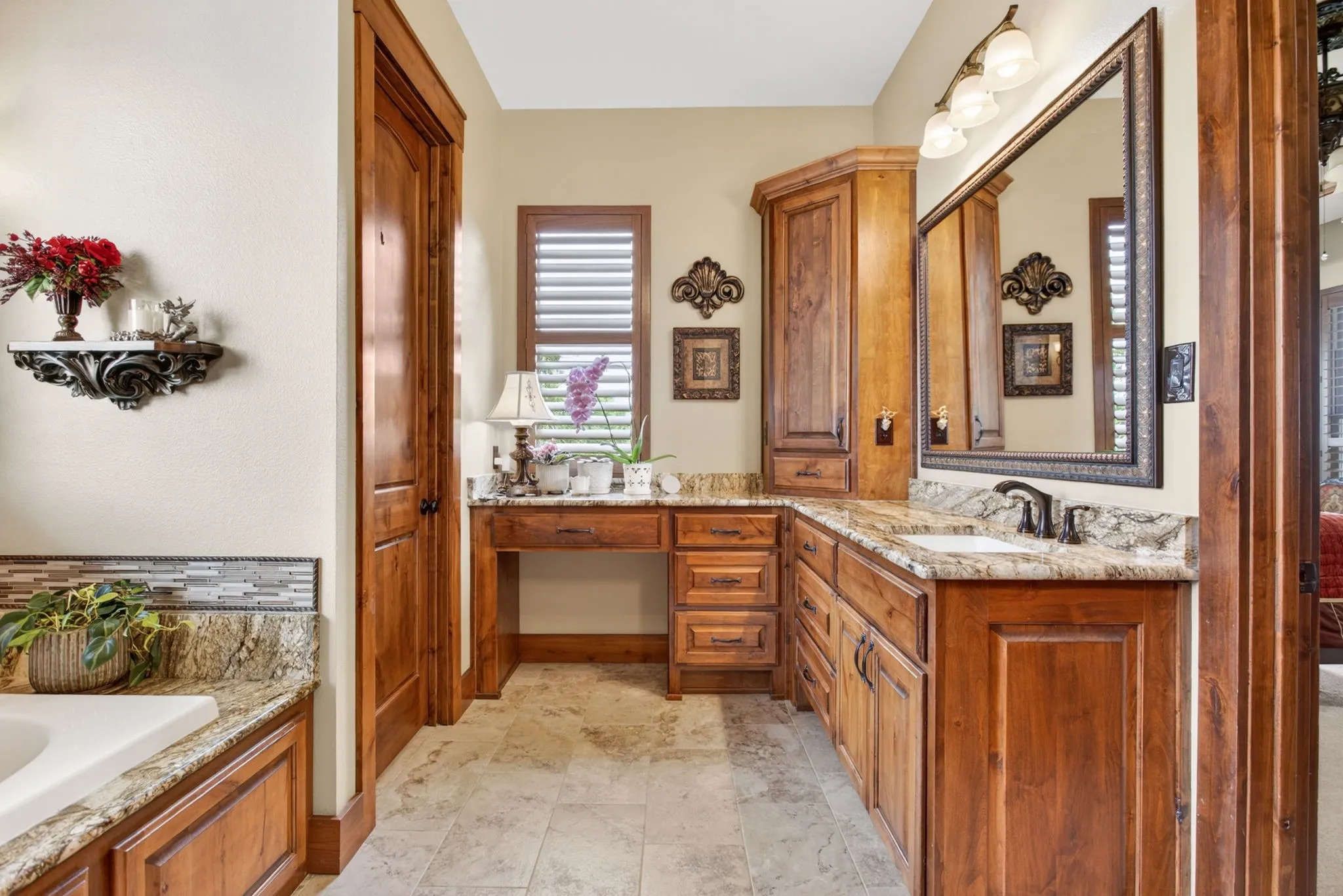 Bathroom featuring extensive wood cabinetry, stone countertops, and tile flooring