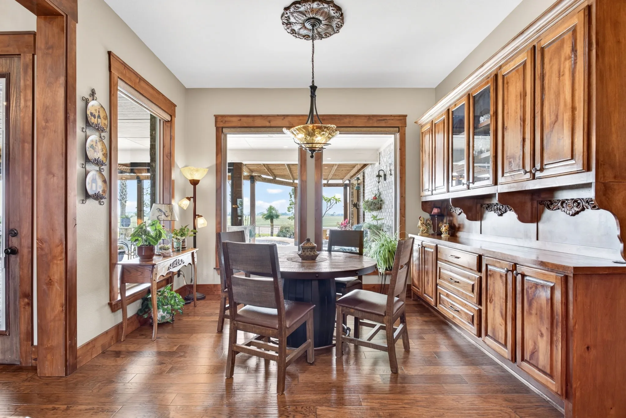 Dining area featuring wood-finish flooring and extensive wood cabinetry
