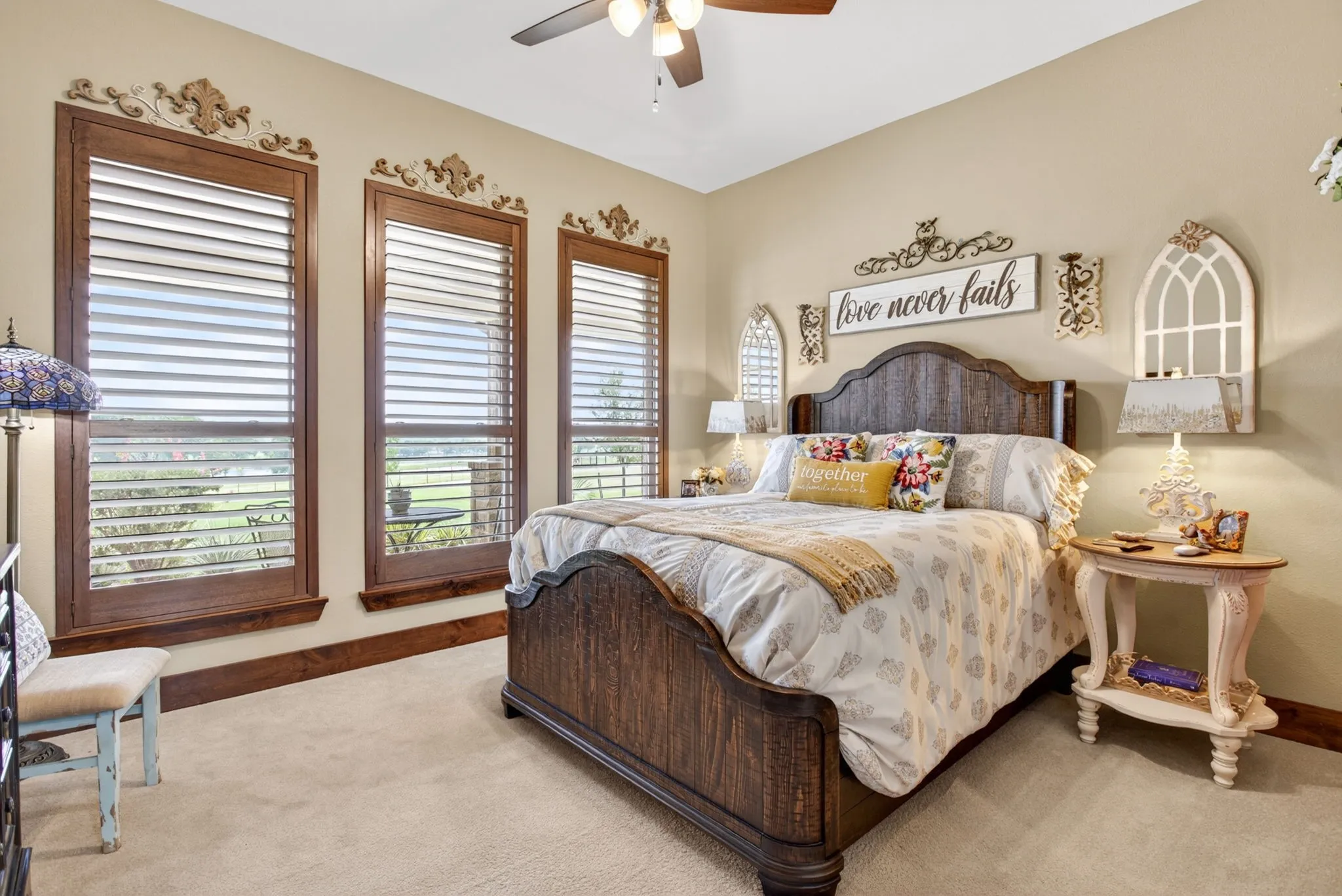 Three large windows with wooden frames and interior plantation shutters