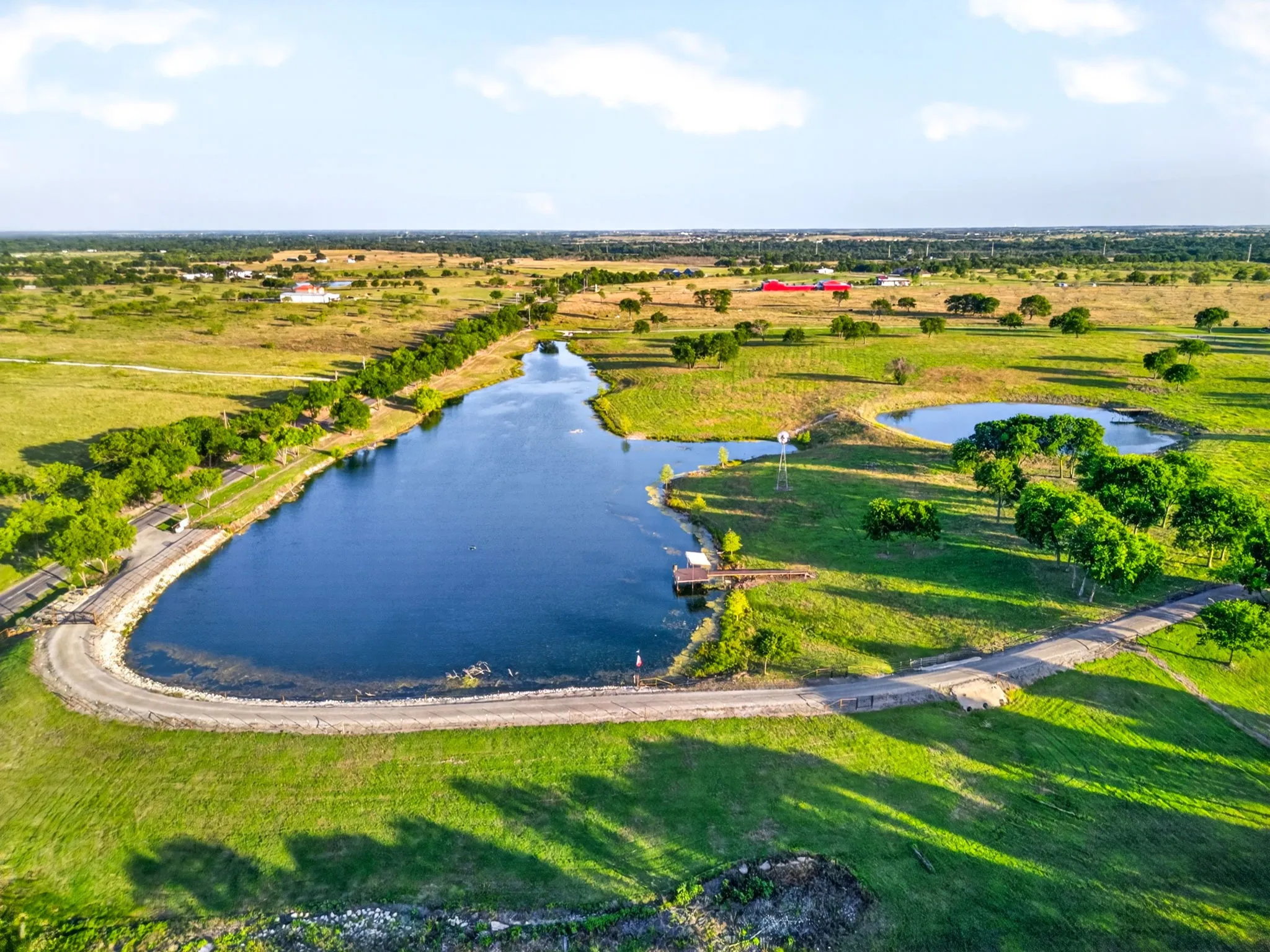 Expansive property featuring a tranquil lake, secondary pond, and a private dock